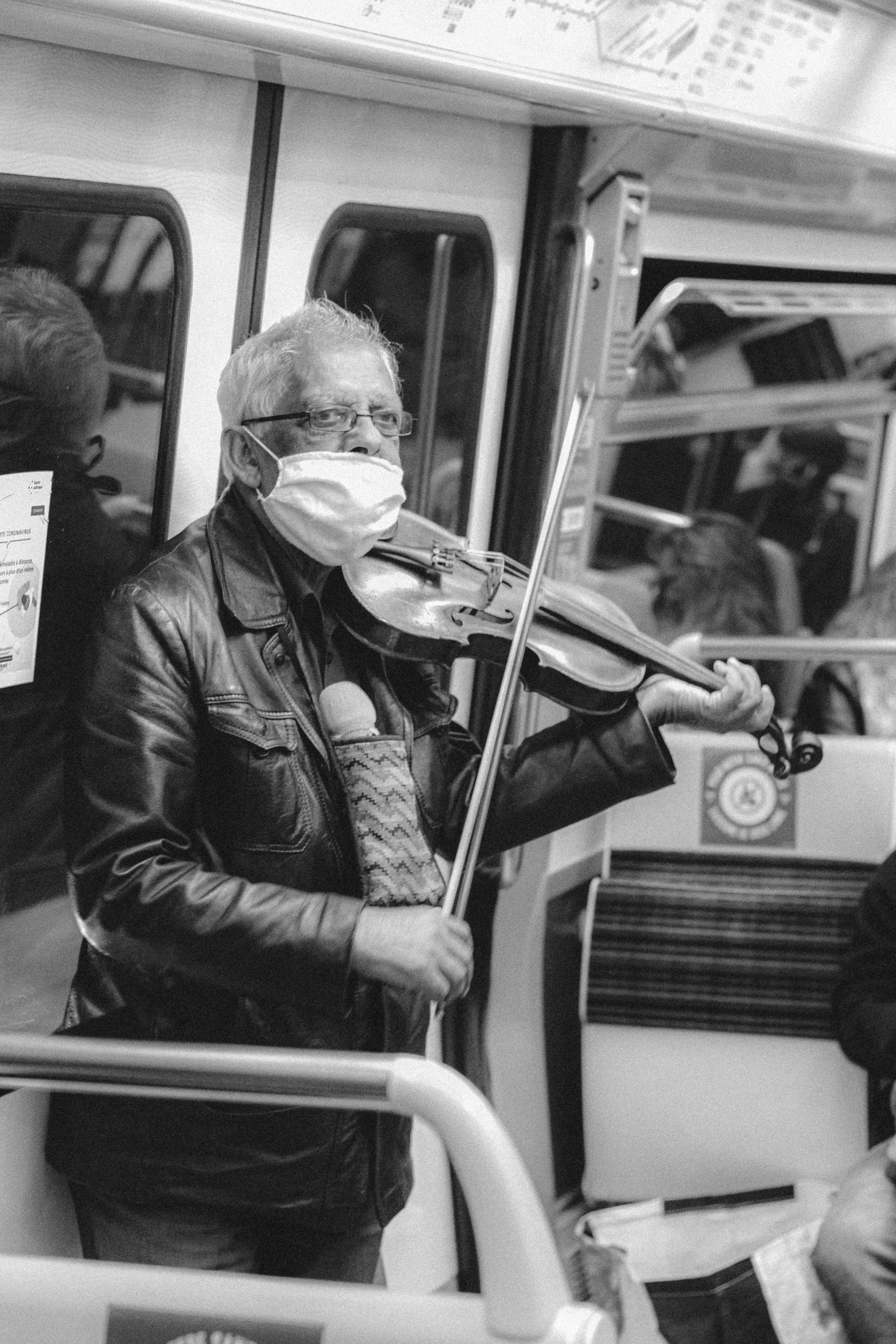 man playing violin in grayscale photography